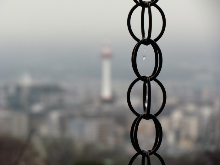 Water dripping down a chain at Kiyomizu dera, looking out over Kyoto in the background